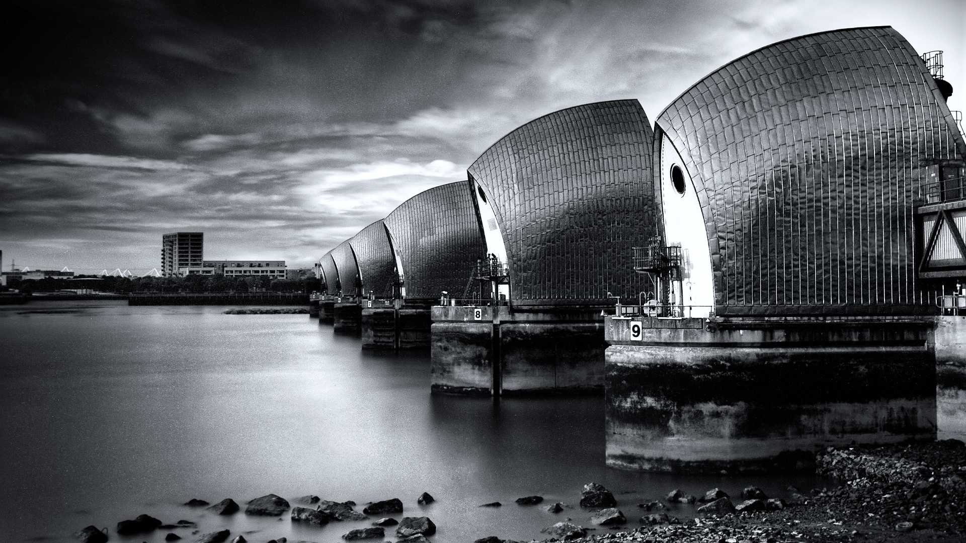 A dramatic, hyper-realistic wide shot of the Thames Barrier